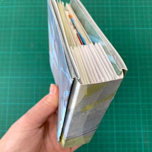 Slip covers with folded spine insert