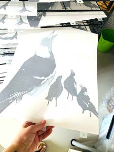 magpies reduction linocut in [rogress for Editions printmaking exhibition