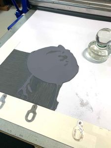 magpies reduction linocut in [rogress for Editions printmaking exhibition