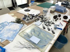 Gelatin plate monoprinting the fronts of each postcard